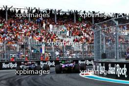 (L to R): Lewis Hamilton (GBR) Mercedes AMG F1 W15 and Yuki Tsunoda (JPN) RB VCARB 01 battle for position. 05.05.2024. Formula 1 World Championship, Rd 6, Miami Grand Prix, Miami, Florida, USA, Race Day.