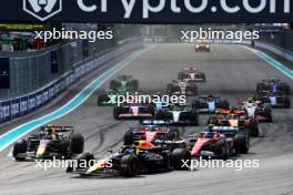 Max Verstappen (NLD) Red Bull Racing RB20 leads a late braking team mate Sergio Perez (MEX) Red Bull Racing RB20 at the start of the race. 05.05.2024. Formula 1 World Championship, Rd 6, Miami Grand Prix, Miami, Florida, USA, Race Day.