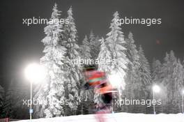 04.01.2011, Oberhof, Germany (GER): Biathlon Feature: Snowy trees with competing athlete - IBU world cup biathlon, training, Oberhof (GER). www.xpb.cc. © Manzoni/xpb.cc. Every downloaded picture is fee-liable.