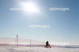 12.03.2011, Khanty-Mansiysk, Russia (RUS): Biathlon Feature: A skier gets ready on the man made hill next to the Alexander Filipenko Ski Center in Khanty Mansiysk - IBU world championships biathlon, training, Khanty-Mansiysk (RUS). www.xpb.cc. © Manzoni/xpb.cc. Every downloaded picture is fee-liable.