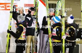 12.03.2011, Lahti, Finland (FIN): team Poland clapping hands with the winners, team Austria  - FIS world cup ski jumping, team HS130, Lahti (FIN). www.xpb.cc. © Laiho/xpb.cc. Every downloaded picture is fee-liable.