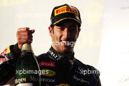 Daniel Ricciardo (AUS) Red Bull Racing celebrates his third position with the champagne on the podium. 16.03.2014. Formula 1 World Championship, Rd 1, Australian Grand Prix, Albert Park, Melbourne, Australia, Race Day.