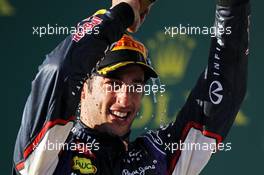 Daniel Ricciardo (AUS) Red Bull Racing celebrates his third position with the champagne on the podium. 16.03.2014. Formula 1 World Championship, Rd 1, Australian Grand Prix, Albert Park, Melbourne, Australia, Race Day.