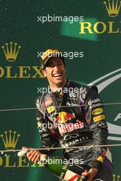 Daniel Ricciardo (AUS) Red Bull Racing celebrates his second position with the champagne on the podium. 16.03.2014. Formula 1 World Championship, Rd 1, Australian Grand Prix, Albert Park, Melbourne, Australia, Race Day.