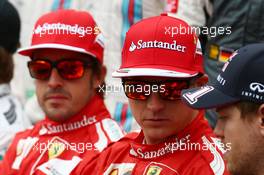 (L to R): Fernando Alonso (ESP) Ferrari with Kimi Raikkonen (FIN) Ferrari and Sebastian Vettel (GER) Red Bull Racing at the drivers start of season photograph. 16.03.2014. Formula 1 World Championship, Rd 1, Australian Grand Prix, Albert Park, Melbourne, Australia, Race Day.