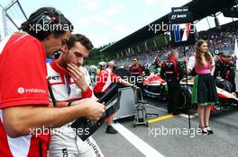 Jules Bianchi (FRA) Marussia F1 Team with Francesco Nenci (ITA) Marussia F1 Team Race Engineer on the grid. 22.06.2014. Formula 1 World Championship, Rd 8, Austrian Grand Prix, Spielberg, Austria, Race Day.
