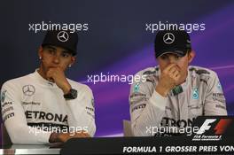 (L to R): Lewis Hamilton (GBR) Mercedes AMG F1 and team mate Nico Rosberg (GER) Mercedes AMG F1 in the post race FIA Press Conference. 22.06.2014. Formula 1 World Championship, Rd 8, Austrian Grand Prix, Spielberg, Austria, Race Day.