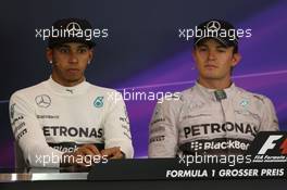 (L to R): Lewis Hamilton (GBR) Mercedes AMG F1 and team mate Nico Rosberg (GER) Mercedes AMG F1 in the post race FIA Press Conference. 22.06.2014. Formula 1 World Championship, Rd 8, Austrian Grand Prix, Spielberg, Austria, Race Day.
