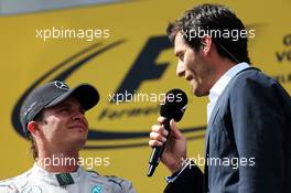(L to R): Race winner Nico Rosberg (GER) Mercedes AMG F1 with Mark Webber (AUS) Porsche Team WEC Driver on the podium. 22.06.2014. Formula 1 World Championship, Rd 8, Austrian Grand Prix, Spielberg, Austria, Race Day.