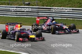 Sebastian Vettel (GER) Red Bull Racing RB10 and Jean-Eric Vergne (FRA) Scuderia Toro Rosso STR9. 22.06.2014. Formula 1 World Championship, Rd 8, Austrian Grand Prix, Spielberg, Austria, Race Day.