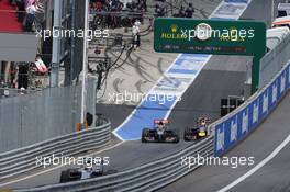 Kevin Magnussen (DEN) McLaren MP4-29 leads out of the pits ahead of Daniil Kvyat (RUS) Scuderia Toro Rosso STR9 and Daniel Ricciardo (AUS) Red Bull Racing RB10. 22.06.2014. Formula 1 World Championship, Rd 8, Austrian Grand Prix, Spielberg, Austria, Race Day.