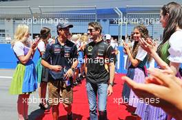 (L to R): Daniel Ricciardo (AUS) Red Bull Racing with Romain Grosjean (FRA) Lotus F1 Team on the drivers parade. 22.06.2014. Formula 1 World Championship, Rd 8, Austrian Grand Prix, Spielberg, Austria, Race Day.