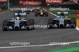 (L to R): Lewis Hamilton (GBR) Mercedes AMG F1 W05 and team mate Nico Rosberg (GER) Mercedes AMG F1 W05 battle for position shortly before making contact. 24.08.2014. Formula 1 World Championship, Rd 12, Belgian Grand Prix, Spa Francorchamps, Belgium, Race Day.