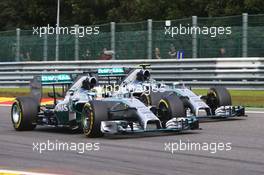 Lewis Hamilton (GBR) Mercedes AMG F1 W05 and team mate Nico Rosberg (GER) Mercedes AMG F1 W05 battle for position shortly before making contact. 24.08.2014. Formula 1 World Championship, Rd 12, Belgian Grand Prix, Spa Francorchamps, Belgium, Race Day.