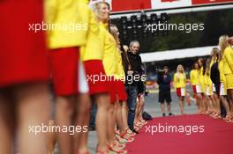 Grid girls on the drivers parade and Mark Thompson (GBR) Getty Images Photographer. 24.08.2014. Formula 1 World Championship, Rd 12, Belgian Grand Prix, Spa Francorchamps, Belgium, Race Day.
