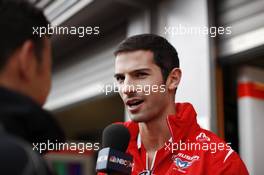 Alexander Rossi (USA) Marussia F1 Team with Will Buxton (GBR) NBS Sports Network TV Presenter. 21.08.2014. Formula 1 World Championship, Rd 12, Belgian Grand Prix, Spa Francorchamps, Belgium, Preparation Day.
