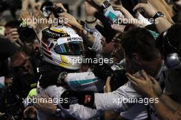 Race winner Lewis Hamilton (GBR) Mercedes AMG F1 celebrates with the team in parc ferme. 06.04.2014. Formula 1 World Championship, Rd 3, Bahrain Grand Prix, Sakhir, Bahrain, Race Day.