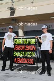 (L to R): Jenson Button (GBR) McLaren celebrates his 250th GP with team mate Kevin Magnussen (DEN) McLaren. 06.04.2014. Formula 1 World Championship, Rd 3, Bahrain Grand Prix, Sakhir, Bahrain, Race Day.