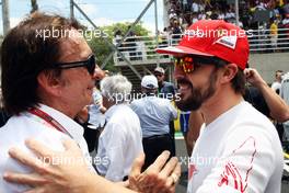 (L to R): Emerson Fittipaldi (BRA) with Fernando Alonso (ESP) Ferrari on the grid. 09.11.2014. Formula 1 World Championship, Rd 18, Brazilian Grand Prix, Sao Paulo, Brazil, Race Day.