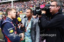 Sebastian Vettel (GER) Red Bull Racing on the grid with Kai Ebel (GER) RTL TV Presenter. 20.04.2014. Formula 1 World Championship, Rd 4, Chinese Grand Prix, Shanghai, China, Race Day.
