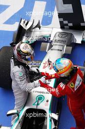 Race winner Lewis Hamilton (GBR) Mercedes AMG F1 W05 celebrates in parc ferme with Fernando Alonso (ESP) Ferrari. 20.04.2014. Formula 1 World Championship, Rd 4, Chinese Grand Prix, Shanghai, China, Race Day.