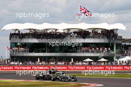 Lewis Hamilton (GBR) Mercedes AMG F1 W05 leads Jenson Button (GBR) McLaren MP4-29. 06.07.2014. Formula 1 World Championship, Rd 9, British Grand Prix, Silverstone, England, Race Day.