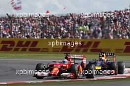 Fernando Alonso (ESP) Ferrari F14-T leads Sebastian Vettel (GER) Red Bull Racing RB10. 06.07.2014. Formula 1 World Championship, Rd 9, British Grand Prix, Silverstone, England, Race Day.