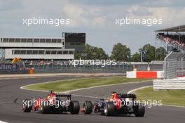 Fernando Alonso (ESP) Ferrari F14-T and Sebastian Vettel (GER) Red Bull Racing RB10 battle for position. 06.07.2014. Formula 1 World Championship, Rd 9, British Grand Prix, Silverstone, England, Race Day.