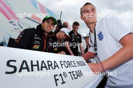 (L to R): Sergio Perez (MEX) Sahara Force India F1 and team mate Nico Hulkenberg (GER) Sahara Force India F1 sign autographs for the fans. 05.07.2014. Formula 1 World Championship, Rd 9, British Grand Prix, Silverstone, England, Qualifying Day.