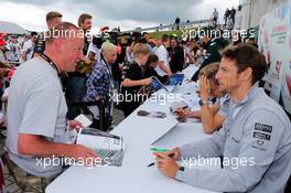 Jenson Button (GBR) McLaren signs autographs for the fans. 05.07.2014. Formula 1 World Championship, Rd 9, British Grand Prix, Silverstone, England, Qualifying Day.