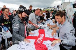 Jenson Button (GBR) McLaren signs autographs for the fans. 05.07.2014. Formula 1 World Championship, Rd 9, British Grand Prix, Silverstone, England, Qualifying Day.