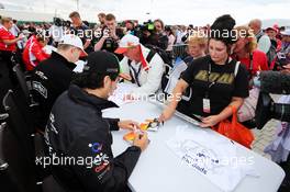 (L to R): Nico Hulkenberg (GER) Sahara Force India F1 and team mate Sergio Perez (MEX) Sahara Force India F1 sign autographs for the fans. 05.07.2014. Formula 1 World Championship, Rd 9, British Grand Prix, Silverstone, England, Qualifying Day.