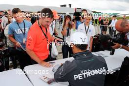 Lewis Hamilton (GBR) Mercedes AMG F1 signs autographs for the fans. 05.07.2014. Formula 1 World Championship, Rd 9, British Grand Prix, Silverstone, England, Qualifying Day.