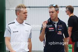 (L to R): Kevin Magnussen (DEN) McLaren with Sebastian Vettel (GER) Red Bull Racing. 25.07.2014. Formula 1 World Championship, Rd 11, Hungarian Grand Prix, Budapest, Hungary, Practice Day.