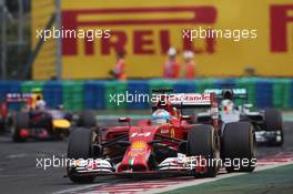 Fernando Alonso (ESP) Ferrari F14-T leads Lewis Hamilton (GBR) Mercedes AMG F1 W05 and Daniel Ricciardo (AUS) Red Bull Racing RB10.. 27.07.2014. Formula 1 World Championship, Rd 11, Hungarian Grand Prix, Budapest, Hungary, Race Day.