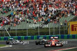 Fernando Alonso (ESP) Ferrari F14-T leads Lewis Hamilton (GBR) Mercedes AMG F1 W05 and Nico Rosberg (GER) Mercedes AMG F1 W05. 27.07.2014. Formula 1 World Championship, Rd 11, Hungarian Grand Prix, Budapest, Hungary, Race Day.