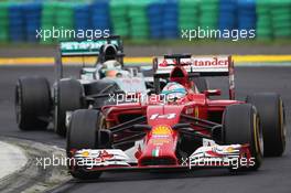 Fernando Alonso (ESP) Ferrari F14-T leads Lewis Hamilton (GBR) Mercedes AMG F1 W05. 27.07.2014. Formula 1 World Championship, Rd 11, Hungarian Grand Prix, Budapest, Hungary, Race Day.