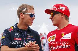 (L to R): Sebastian Vettel (GER) Red Bull Racing and Kimi Raikkonen (FIN) Ferrari on the drivers parade. 27.07.2014. Formula 1 World Championship, Rd 11, Hungarian Grand Prix, Budapest, Hungary, Race Day.