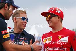 (L to R): Jean-Eric Vergne (FRA) Scuderia Toro Rosso; Sebastian Vettel (GER) Red Bull Racing; and Kimi Raikkonen (FIN) Ferrari on the drivers parade. 27.07.2014. Formula 1 World Championship, Rd 11, Hungarian Grand Prix, Budapest, Hungary, Race Day.
