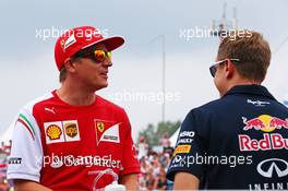 (L to R): Kimi Raikkonen (FIN) Ferrari and Sebastian Vettel (GER) Red Bull Racing on the drivers parade. 27.07.2014. Formula 1 World Championship, Rd 11, Hungarian Grand Prix, Budapest, Hungary, Race Day.