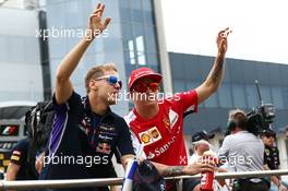 (L to R): Sebastian Vettel (GER) Red Bull Racing and Kimi Raikkonen (FIN) Ferrari on the drivers parade. 27.07.2014. Formula 1 World Championship, Rd 11, Hungarian Grand Prix, Budapest, Hungary, Race Day.