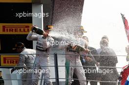 (L to R): Nico Rosberg (GER) Mercedes AMG F1 and race winner Lewis Hamilton (GBR) Mercedes AMG F1 celebrate on the podium. 07.09.2014. Formula 1 World Championship, Rd 13, Italian Grand Prix, Monza, Italy, Race Day.