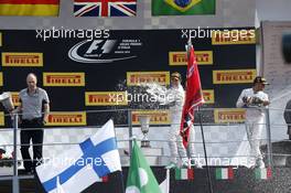 (L to R): Nico Rosberg (GER) Mercedes AMG F1 and team mate Lewis Hamilton (GBR) Mercedes AMG F1 celebrates on the podium. 07.09.2014. Formula 1 World Championship, Rd 13, Italian Grand Prix, Monza, Italy, Race Day.