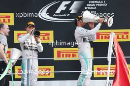 Race winner Lewis Hamilton (GBR) Mercedes AMG F1 (Right) celebrates on the podium with team mate Lewis Hamilton (GBR) Mercedes AMG F1 (Left). 07.09.2014. Formula 1 World Championship, Rd 13, Italian Grand Prix, Monza, Italy, Race Day.