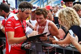 Jules Bianchi (FRA) Marussia F1 Team signs autographs for the fans. 04.09.2014. Formula 1 World Championship, Rd 13, Italian Grand Prix, Monza, Italy, Preparation Day.