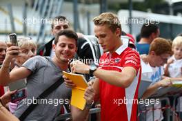 Max Chilton (GBR) Marussia F1 Team signs autographs for the fans. 04.09.2014. Formula 1 World Championship, Rd 13, Italian Grand Prix, Monza, Italy, Preparation Day.