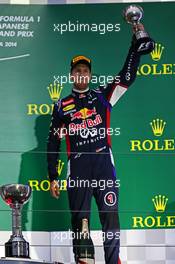 Sebastian Vettel (GER) Red Bull Racing celebrates his third position on the podium. 05.10.2014. Formula 1 World Championship, Rd 15, Japanese Grand Prix, Suzuka, Japan, Race Day.