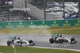 Lewis Hamilton (GBR) Mercedes AMG F1 W05 passes team mate Nico Rosberg (GER) Mercedes AMG F1 W05 to take the lead of the race. 05.10.2014. Formula 1 World Championship, Rd 15, Japanese Grand Prix, Suzuka, Japan, Race Day.