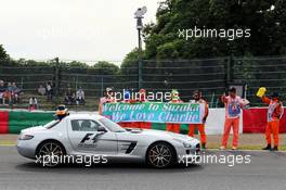 Marshals and fans of Charlie Whiting (GBR) FIA Delegate are passed by him in the FIA Safety Car. 04.10.2014. Formula 1 World Championship, Rd 15, Japanese Grand Prix, Suzuka, Japan, Qualifying Day.
