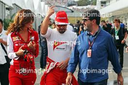 (L to R): Roberta Vallorosi (ITA) Ferrari Press Officer with Fernando Alonso (ESP) Ferrari and Luis Garcia Abad (ESP) Driver Manager. 04.10.2014. Formula 1 World Championship, Rd 15, Japanese Grand Prix, Suzuka, Japan, Qualifying Day.